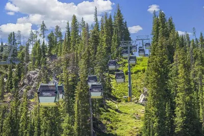 a gondola ride on a ski lift with trees at 4368 Founders Pointe Cozy WP Village Condo in Winter Park