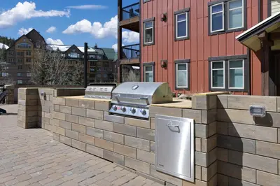 a brick wall with a grill in front of a building at 4368 Founders Pointe Cozy WP Village Condo in Winter Park