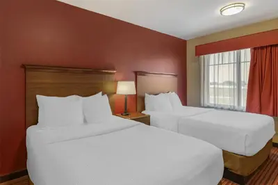 a hotel room with two beds and a window at Best Western Plus Hudson Hotel & Suites in Hudson