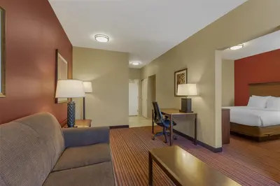 a hotel room with a bed and a couch at Best Western Plus Hudson Hotel & Suites in Hudson