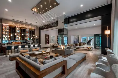 an open living room with couches and a bar at Le Meridien Denver Downtown in Denver