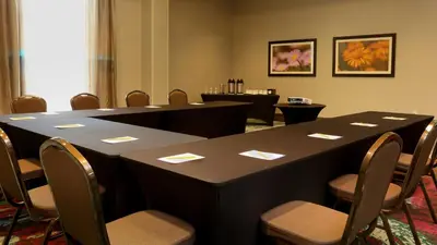 a conference room with a long table and chairs at Hilton Garden Inn Arvada/Denver, CO in Arvada