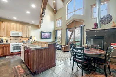 a kitchen with a table and chairs and a fireplace at Dillon Ridge Retreat in Dillon
