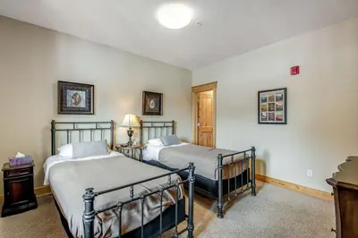 a bedroom with two beds and a table with a lamp at Dillon Ridge Retreat in Dillon
