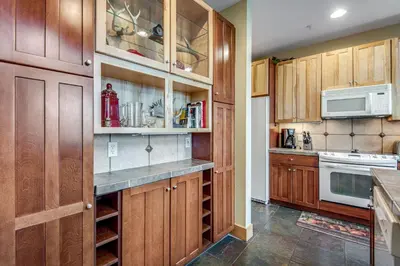 a kitchen with wooden cabinets and a microwave at Dillon Ridge Retreat in Dillon