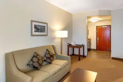 a living room with a couch and a table at MainStay Suites Near Denver Downtown in Denver
