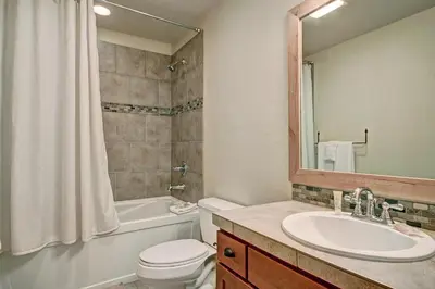 a bathroom with a sink and a toilet and a mirror at 6509 Settlers Creek Townhomes in Keystone