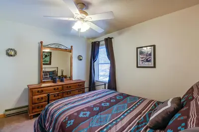 a bedroom with a bed and a dresser and a mirror at Meadow Creek in Frisco