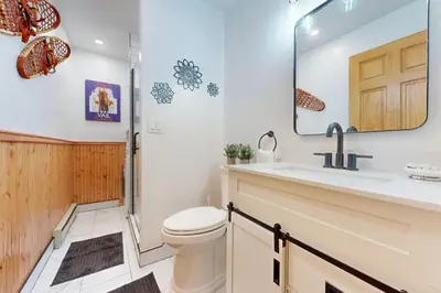 a bathroom with a toilet and a sink and a mirror at Meadow Creek in Frisco
