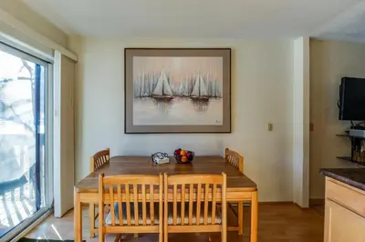 a dining room table with chairs and a painting on the wall at Meadow Creek in Frisco