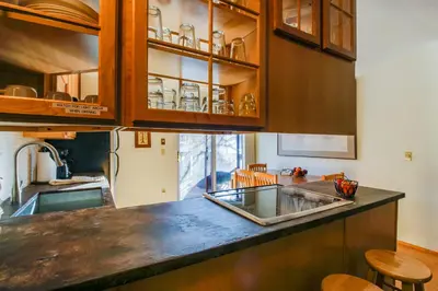 a kitchen with a sink and wooden cabinets at Meadow Creek in Frisco