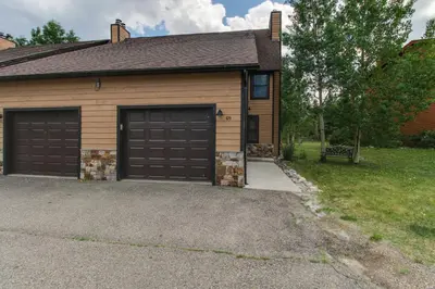 a house with two garage doors and a driveway at Meadow Creek in Frisco