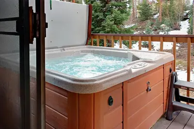 a hot tub sitting on top of a deck at Divide View Townhome in Winter Park