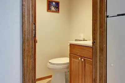 a bathroom with a toilet and a sink at Divide View Townhome in Winter Park