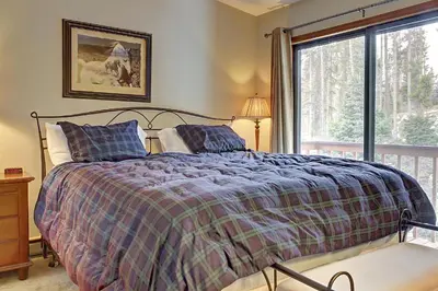 a bedroom with a bed and a window at Divide View Townhome in Winter Park