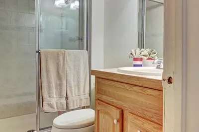 a bathroom with a toilet and a sink and a shower at Divide View Townhome in Winter Park