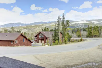 a house on the side of a road next to a mountain at Divide View Townhome in Winter Park