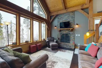 a living room with a couch and a fireplace at Fraser Cabin in the Woods in Fraser