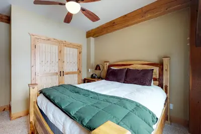 a bedroom with a bed and a ceiling fan at Fraser Cabin in the Woods in Fraser