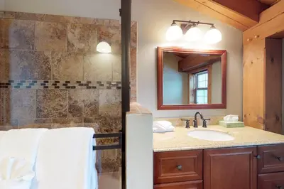a bathroom with a sink and a mirror at Fraser Cabin in the Woods in Fraser