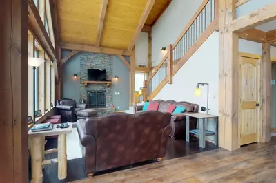 a living room with couches and a fireplace at Fraser Cabin in the Woods in Fraser