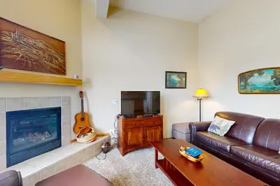 a living room with a couch and a fireplace at Wildernest Gore Trail Condo in Silverthorne