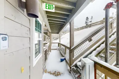 a balcony of a building with snow on the ground at Wildernest Gore Trail Condo in Silverthorne