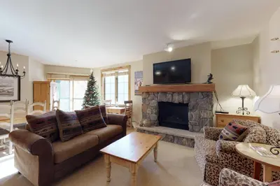 a living room with a couch and a fireplace at The Dakota Outpost in Keystone