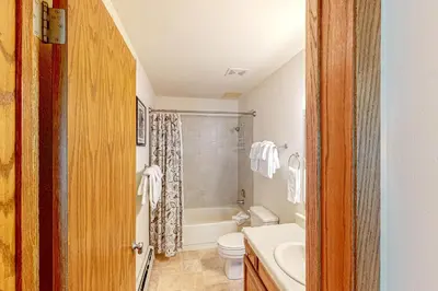 a bathroom with a tub and a toilet and a sink at Buffalo Village Condo & Treetop Hideaway in Silverthorne