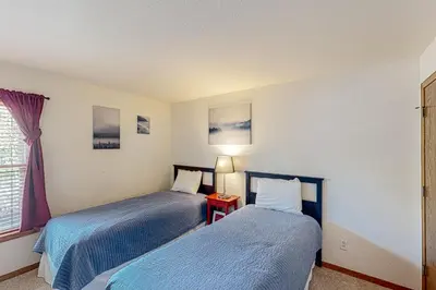 a bedroom with two beds and a window at Buffalo Village Condo & Treetop Hideaway in Silverthorne