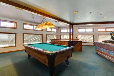 a room with a pool table and a couch at Buffalo Village Condo & Treetop Hideaway in Silverthorne