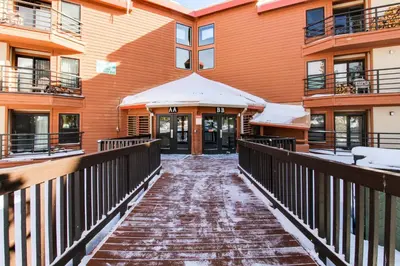 a walkway leading to the front door of a building at Buffalo Village Condo & Treetop Hideaway in Silverthorne