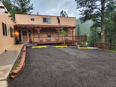 a house with a driveway with yellow barricades in front at Kokopelli Inn in Estes Park