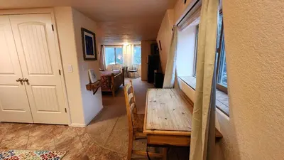 a dining room with a wooden table and a room with a dining room at Kokopelli Inn in Estes Park