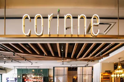a sign for the colos restaurant in a store at AC Hotel by Marriott Denver Downtown in Denver