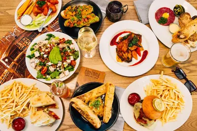 a wooden table with plates of food on it at AC Hotel by Marriott Denver Downtown in Denver