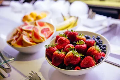two bowls of strawberries and blueberries and fruit on a counter at AC Hotel by Marriott Denver Downtown in Denver