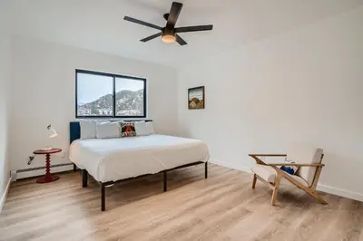 a bedroom with a bed and a ceiling fan at Uplift Inn in Idaho Springs