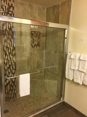 a shower with a glass door in a bathroom at Uplift Inn in Idaho Springs