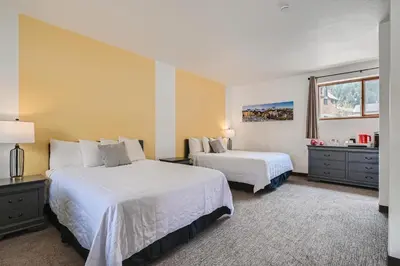a hotel room with two beds and a window at Uplift Inn in Idaho Springs