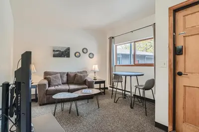 a living room with a couch and a table at Uplift Inn in Idaho Springs