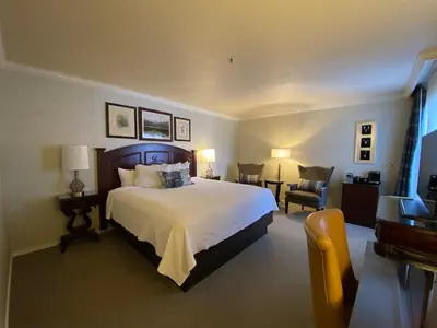 a bedroom with a large white bed and a chair at Hotel Boulderado in Boulder