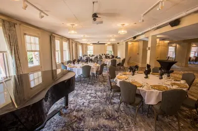 a room filled with tables and chairs with at Hotel Boulderado in Boulder
