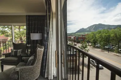 a balcony with chairs and a view of a street at Hotel Boulderado in Boulder