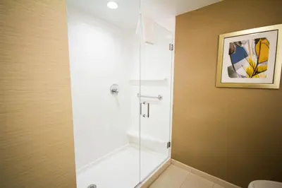 a bathroom with a shower with a glass door at Fairfield Inn & Suites by Marriott Denver Northeast/Brighton in Brighton