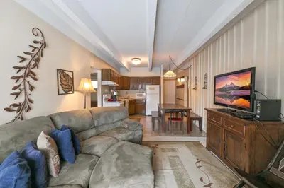 a living room with a couch and a kitchen at Ten Mile Creek Condo: Downtown Frisco, Hot Tub in Frisco