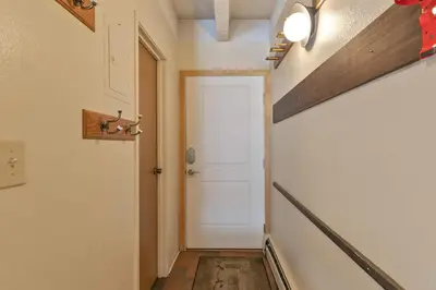 a hallway with a white door and a floor at Ten Mile Creek Condo: Downtown Frisco, Hot Tub in Frisco
