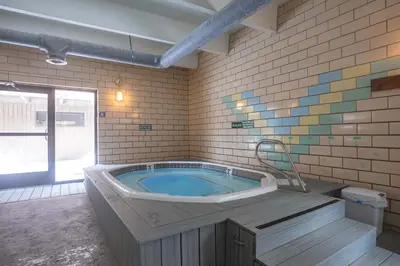a large bathroom with a jacuzzi tub with a chair at Ten Mile Creek Condo: Downtown Frisco, Hot Tub in Frisco