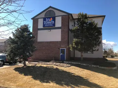 a building with a sign that reads in town suites at InTown Suites Extended Stay Denver - Havana Street in Aurora