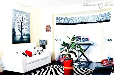 a living room with a white couch and a zebra rug at Airport Lay Over in Denver